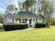 Charming one story home with stone accents, manicured lawn, and welcoming front porch at 25 Derby Dr, Hiram, GA 30141
