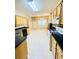 Bright kitchen with tile flooring, light-colored cabinets and stainless steel appliances and black countertops at 25 Derby Dr, Hiram, GA 30141