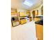Kitchen featuring tile floors, light cabinets, stainless steel refrigerator, black counter tops and recessed lighting at 25 Derby Dr, Hiram, GA 30141
