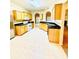 A kitchen with light-colored cabinets, tile floor, black countertops, and stainless steel appliances at 25 Derby Dr, Hiram, GA 30141