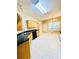 Bright eat-in kitchen features natural wood cabinets, black countertops, and tile floors at 25 Derby Dr, Hiram, GA 30141