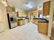 A kitchen with light colored cabinets, stainless steel refrigerator, tile floors and plenty of countertop space at 25 Derby Dr, Hiram, GA 30141