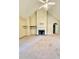 Bright living room featuring a fireplace with stone hearth, vaulted ceiling, and built-in shelving at 25 Derby Dr, Hiram, GA 30141