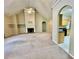 Open living room showcasing a fireplace, arched doorways, and kitchen view at 25 Derby Dr, Hiram, GA 30141