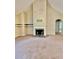 Living room featuring a fireplace, vaulted ceilings, carpeted floors, and an open layout at 25 Derby Dr, Hiram, GA 30141