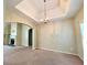 Spacious living room features an elegant chandelier and recessed ceiling design at 25 Derby Dr, Hiram, GA 30141
