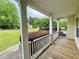 Inviting covered front porch with white railings, offering a pleasant outdoor space and neighborhood views at 25 Derby Dr, Hiram, GA 30141