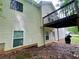 Back exterior of home with elevated deck, lower patio, and walkout basement door at 25 Derby Dr, Hiram, GA 30141