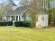 Charming home with stone accents and manicured lawn, offering a serene view of the property's landscaped surroundings at 25 Derby Dr, Hiram, GA 30141