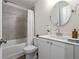 Well-lit bathroom featuring a shower-tub, vanity with mirror, and tiled wall at 711 Needletail Way, Atlanta, GA 30312