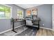 Comfortable home office features a large desk, stylish decor, and natural light at 711 Needletail Way, Atlanta, GA 30312
