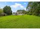 Spacious backyard featuring a lush lawn, trees, and plenty of open space at 1230 Brook Meadow Ct, Lawrenceville, GA 30045