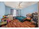 Cozy bedroom features wood-look flooring, ceiling fan, and natural light at 1230 Brook Meadow Ct, Lawrenceville, GA 30045