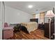 Inviting bedroom featuring hardwood floors, large bed, and a bedside table at 1230 Brook Meadow Ct, Lawrenceville, GA 30045