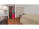 Cozy bedroom featuring hardwood floors, a large bed, closet and dresser at 1230 Brook Meadow Ct, Lawrenceville, GA 30045