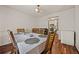 Cozy dining room featuring hardwood floors, seating for six, and a view into the kitchen at 1230 Brook Meadow Ct, Lawrenceville, GA 30045