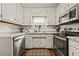 Fully equipped kitchen with vintage white cabinets and stainless steel appliances at 1230 Brook Meadow Ct, Lawrenceville, GA 30045