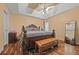 Comfortable bedroom featuring a large bed, bench, and hardwood floors at 1230 Brook Meadow Ct, Lawrenceville, GA 30045