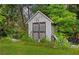 Outdoor shed is surrounded by a lush green yard and trees at 1230 Brook Meadow Ct, Lawrenceville, GA 30045