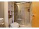 Modern bathroom with glass shower, toilet, and storage shelving at 1133 Church St # 6, Covington, GA 30014