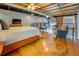 Inviting bedroom featuring a comfortable bed, polished floors, exposed ductwork, and scenic views from windows at 1133 Church St # 6, Covington, GA 30014
