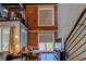 Bright living area with high ceilings, brick accent wall, and metal staircase at 1133 Church St # 6, Covington, GA 30014