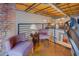 Stylish loft living room with exposed brick and modern design elements and overhead natural wood ceiling at 1133 Church St # 6, Covington, GA 30014