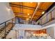 Open living area with loft, stairs, kitchen, and exposed ductwork at 1133 Church St # 6, Covington, GA 30014