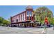 This building features a red brick exterior with black awnings and is located on a tree-lined street at 1133 Church St # 6, Covington, GA 30014