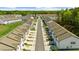 An aerial view showcases modern townhomes with well-maintained landscaping in a neatly planned community at 125 Auburn Gate Ln, Auburn, GA 30011