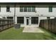 Backyard with lush green grass, a fence, and a white brick exterior at 125 Auburn Gate Ln, Auburn, GA 30011