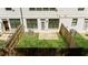 Backyard with artificial lush green grass, fences, and air conditioning units at 125 Auburn Gate Ln, Auburn, GA 30011