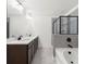Modern bathroom featuring double vanity, white countertops, tile floors, and a glass-enclosed shower at 125 Auburn Gate Ln, Auburn, GA 30011