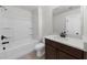 Bathroom featuring a modern vanity, white countertops, dark wood cabinets and a tub with a shower at 125 Auburn Gate Ln, Auburn, GA 30011
