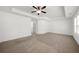 Spacious bedroom featuring neutral carpet, a ceiling fan, and ample natural light at 125 Auburn Gate Ln, Auburn, GA 30011