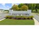 The Towne's of Auburn entrance sign surrounded by manicured bushes at 125 Auburn Gate Ln, Auburn, GA 30011