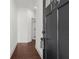 Modern entryway with dark hardwood floors, white walls, and a stylish dark-colored door at 125 Auburn Gate Ln, Auburn, GA 30011