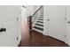 Inviting entryway featuring hardwood floors, a staircase with dark railing, and neutral decor at 125 Auburn Gate Ln, Auburn, GA 30011