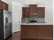 Modern kitchen featuring stainless steel appliances, an island, and ample cabinet space at 125 Auburn Gate Ln, Auburn, GA 30011