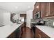 Modern kitchen features stainless steel appliances, wooden cabinets, and sleek countertops at 125 Auburn Gate Ln, Auburn, GA 30011