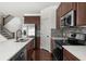 Modern kitchen features stainless steel appliances, wooden cabinets, and sleek countertops at 125 Auburn Gate Ln, Auburn, GA 30011