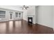 Bright living room featuring hardwood floors, a fireplace, and large windows for natural light at 125 Auburn Gate Ln, Auburn, GA 30011