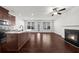 Open-concept living space with hardwood floors, fireplace, and island at 125 Auburn Gate Ln, Auburn, GA 30011
