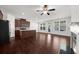 Open-concept living space with hardwood floors, fireplace, and island at 125 Auburn Gate Ln, Auburn, GA 30011