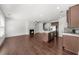 Open-concept living space with hardwood floors, fireplace, and island at 125 Auburn Gate Ln, Auburn, GA 30011