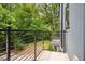 A lovely outdoor balcony with black iron railings shows a view of the green backyard at 1570 Flat Shoals Se Rd # 7, Atlanta, GA 30316