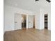 Spacious bedroom with hardwood floors, neutral paint, and doors to an ensuite bathroom at 1570 Flat Shoals Se Rd # 7, Atlanta, GA 30316