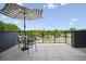 Relaxing patio area with a table, chairs, and a striped umbrella, perfect for outdoor entertaining at 1570 Flat Shoals Se Rd # 7, Atlanta, GA 30316