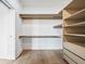 Bright walk-in closet featuring custom built-in shelving and hardwood floors at 1570 Flat Shoals Se Rd # 7, Atlanta, GA 30316