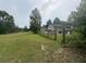 Sprawling backyard view with shed and wooden deck on a well-maintained lawn at 177 New Hope Cir, Fayetteville, GA 30214
